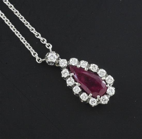 An 18ct white gold, ruby and diamond set drop pendant necklace, pendant 24mm.